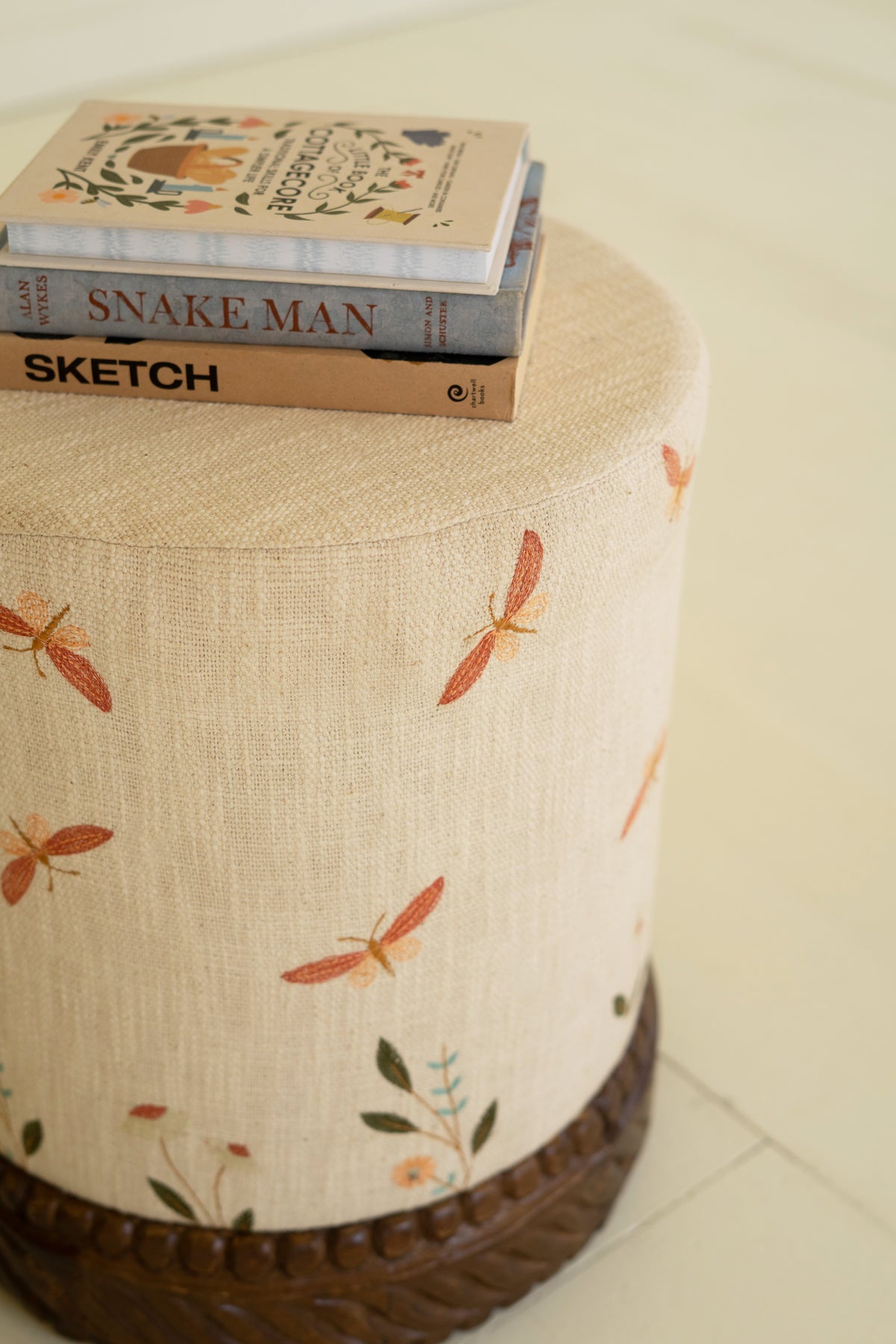 Upholstered Ottoman with Carved Wood Base - Cream